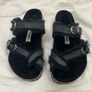 Black Furry Birkenstock sandal with toe strap and double buckle closure